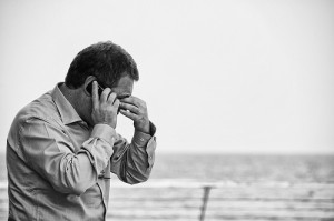 Worried man talking on a cellphone