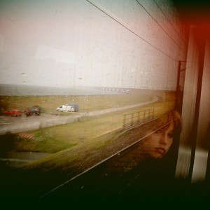 Woman looking out a train window by BjArn Giesenbauer on Flickr