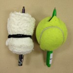 Pens stuck through rolled-up washcloth and tennis ball