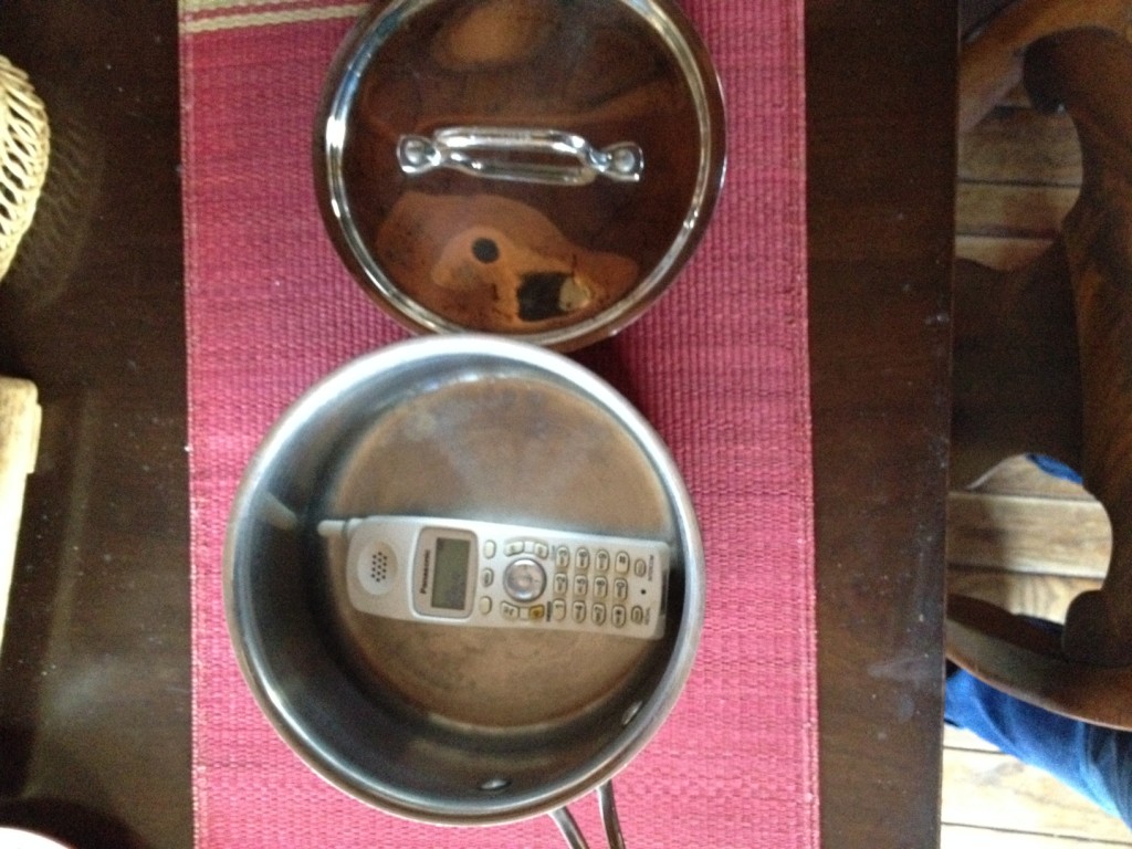 Mute the phone in a sauce pan with a lid