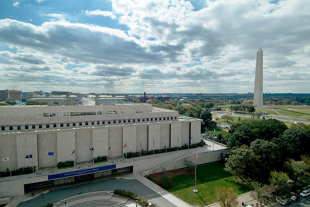 Exterior of the National Museum of American History in Washington, DC, with the Washington Monument in the background