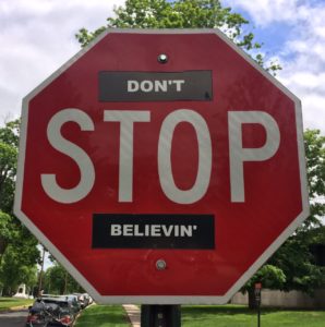 Red Stop sign with stickers, so it reads: DON'T STOP BELIEVING